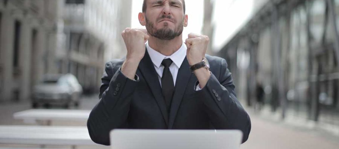 man-in-black-suit-sitting-on-chair-beside-buildings-3778966 man-in-black-suit-sitting-on-chair-beside-buildings-3778966